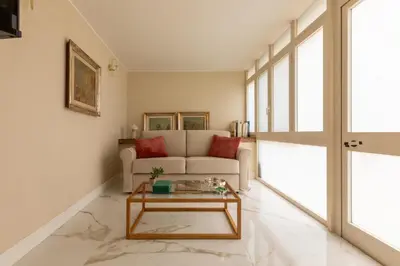 a living room with a couch and a table at Casa Gold by Hili in Rome