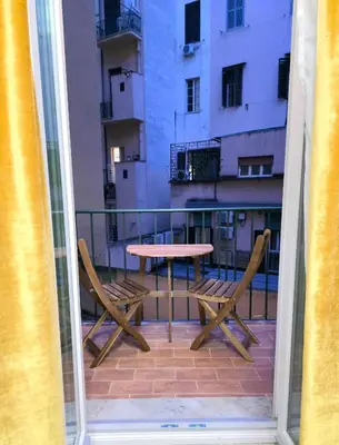 a table and two chairs on a balcony with a table at Victoria Suites in Rome