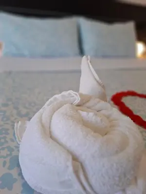 a white towel sitting on top of a bed at Luma rooms in Rome