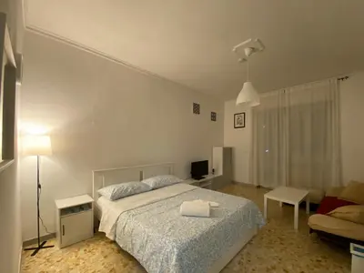 a bedroom with a bed and a living room at Tiburtina2000 in Rome