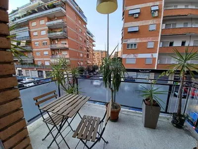a balcony with two chairs and a table and plants at Tiburtina2000 in Rome