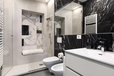 a bathroom with a toilet and a sink and a shower at Idyllia - Borgognona luxury home in Rome