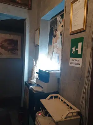 a room with a desk with a computer on a wall at Arneil Rooms Rome in Rome