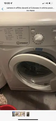 a close up of a washing machine with the door open at Colosseo28 three private rooms in Rome
