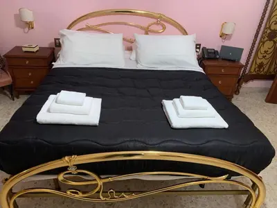 a bed with two towels on top of it at Millys Apartment Rome Centre 