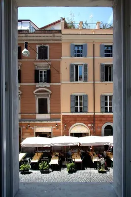 a view from a window of a building with tables and umbrellas at Apartment Ripa 17 in Rome