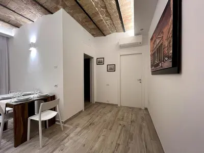 a dining room with a table and chairs and a painting at ARTPA Rome Apartments Trastevere Mameli, Roma in Rome