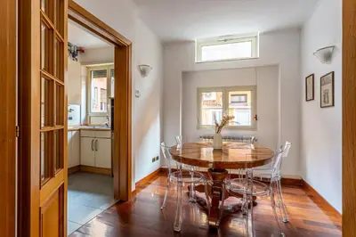 a kitchen and dining room with a table and chairs at iFlat The Roman House - Spacious & Central Apt in Rome