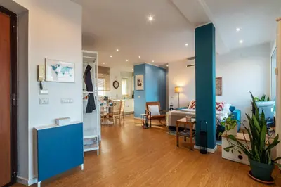 a living room with a bed and a dining room at Terrazza d'autore in Rome