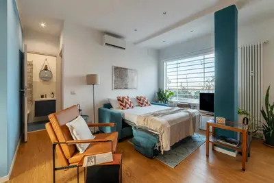 a bedroom with a bed and a couch and a tv at Terrazza d'autore in Rome