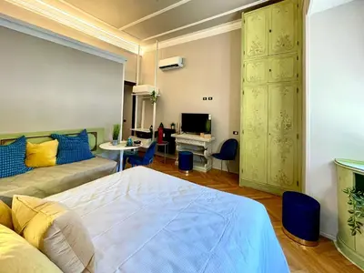 a bedroom with a bed and a desk and a television at Z-ArchSuites URBE in Rome