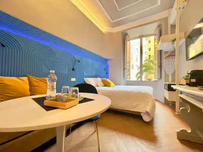 a hotel room with a bed and a table and a room at Z-ArchSuites URBE in Rome