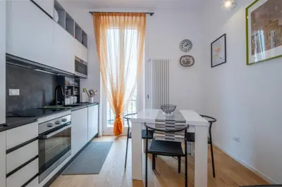 a kitchen with a table and a dining room at ht siesta sistina in Rome