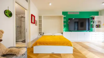 a bedroom with a yellow bed and a green wall at Villa Paolina by Rentbeat in Rome