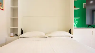 a white bed with two pillows in a room at Villa Paolina by Rentbeat in Rome