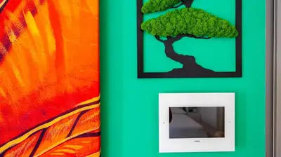 a picture of a tree on a wall next to a picture frame at Villa Paolina by Rentbeat in Rome