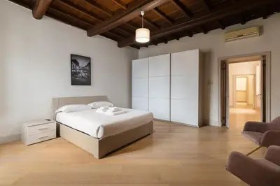 a bedroom with a bed and a white cabinet at Roma - Parione House in Rome