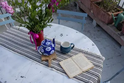 a table with a book and a cup of coffee and a book at Governo Central Apartment in Rome