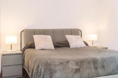 a large bed with two nightstands and two lamps at Susy's Lovely Flat near Trastevere in Rome