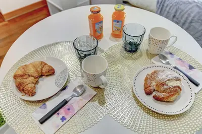 a white table with two plates of pastries on it at Colosseo - MecenStudio - Home and More in Rome