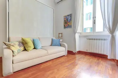 a living room with a couch and a window at Colosseo - MecenStudio - Home and More in Rome