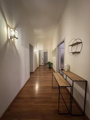 a hallway with a table and a bench in a room at Dreamingrome in Rome
