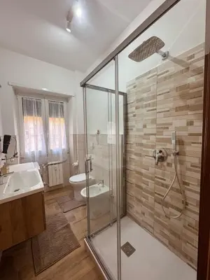 a bathroom with a shower and a sink and a toilet at Re di Roma Living in Rome