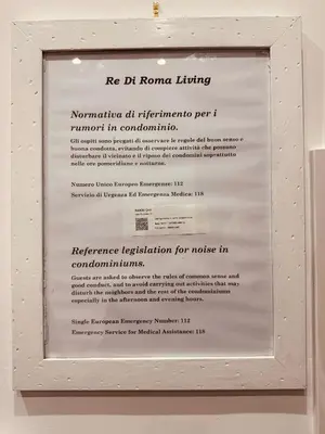 a framed picture of a document in a white frame at Re di Roma Living in Rome