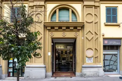 a building with a door and a tree in front of it at Domus Vespignani in Metro Lodi e San Giovanni - The Bright Spot in Rome