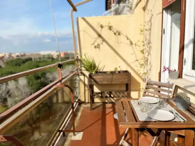 a wooden table on a balcony with a view at Yellow Sweet Home in Rome