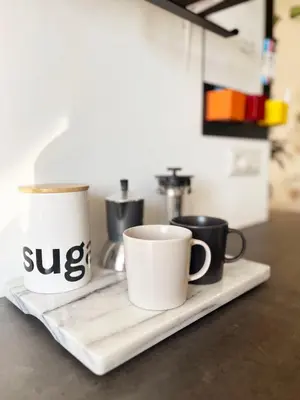 two coffee mugs sitting on a tray on a counter at Yellow Sweet Home in Rome