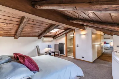 a bedroom with wooden ceilings and a bed in a room at Massimo 60 apartment by Roman Dreams in Rome