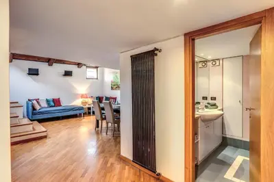 a living room and dining room with a blue couch at Massimo 60 apartment by Roman Dreams in Rome