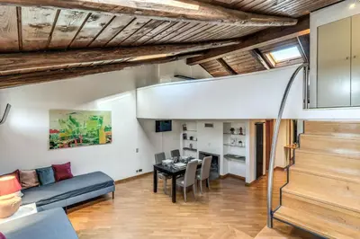 a living room with a table and a dining room at Massimo 60 apartment by Roman Dreams in Rome