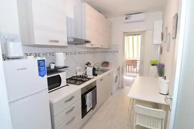 a bedroom with a blue bed and a picture of a plane at Roma Metro Apartment in Rome