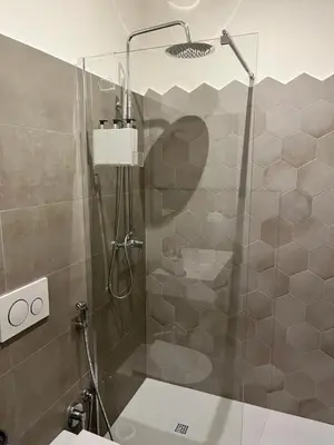 a shower with a glass door in a bathroom at Palmira house in Rome