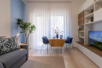 a living room with a couch and a table at Grazia Appartamento Moderno & Chic a Tiburtina in Rome
