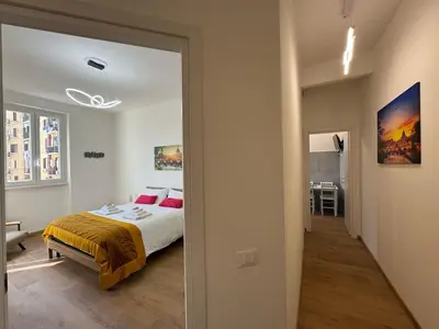 a bedroom with a bed and a hallway at Urban Retreat Steps from the Metro in Rome