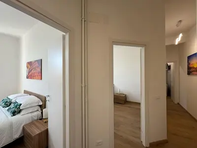 a bedroom with a bed and a door leading to a hallway at Urban Retreat Steps from the Metro in Rome