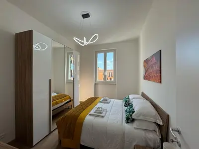 a bedroom with a large bed and a mirror at Urban Retreat Steps from the Metro in Rome