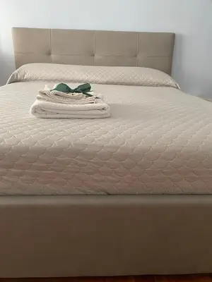 a stack of towels sitting on a bed at Camilluccia Home close to St Peter Stadio Olimpico in Rome