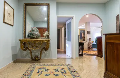 a hallway with a mirror and a table with a vase at Camilluccia Home close to St Peter Stadio Olimpico in Rome
