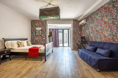 a living room with a couch and a bed at Eco Retreat -Sauna & Garden in Rome