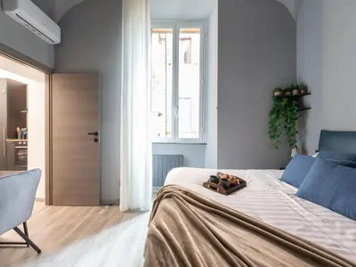 a bedroom with a large bed and a window at The Best Rent - Modern One-Bedroom Apartment in Trastevere in Rome