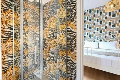 a room with a tiger print wallpaper at Cozy Studio Steps from Metro station in Rome