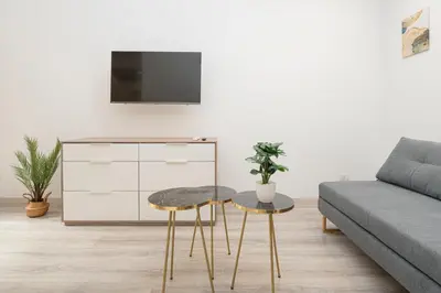 a living room with a couch and two stools at Piazza Cavour Apartment 90 in Rome