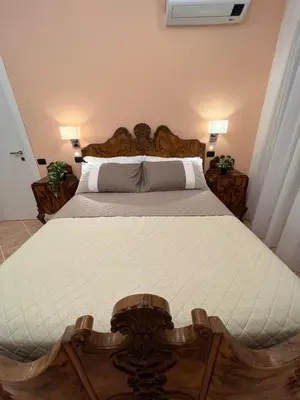 a large bed in a bedroom with two lamps at ARTPA Rome Apartments Gianicolo, Roma in Rome