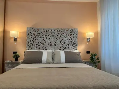 a bedroom with a large bed with a large headboard at ARTPA Rome Apartments Gianicolo, Roma in Rome