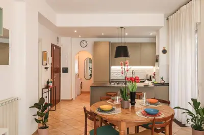a kitchen and dining room with a table and chairs at Oasi di relax a Monteverde in Rome