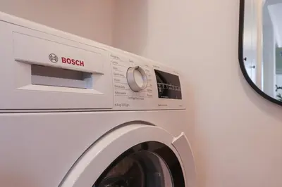 a white washing machine in a white room at Oasi di relax a Monteverde in Rome